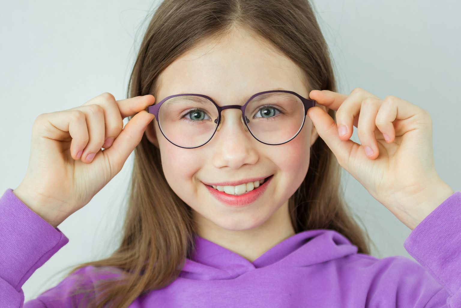 Pretty little girl in colored-rimmed glasses. Glasses for children.